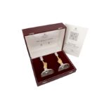 A cased pair of Elizabeth II parcel gilt sterling silver commemorative candlesticks, London 1977 by