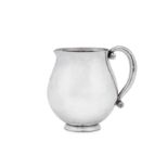 An early 20th century Danish sterling silver cream jug, Copenhagen by Georg Jensen, import marks