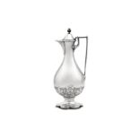 A Victorian sterling silver ecclesiastical flagon, London 1873 by John, Edward, Walter & John