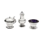 An Edwardian ‘Arts and Crafts’ sterling silver three-piece cruet, Birmingham 1905 by Liberty and Co