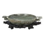 A CHINESE GREEN-GREY JADE OFFERING DISH