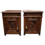 A PAIR OF CONTINENTAL CARVED ELM BEDSIDE CABINETS