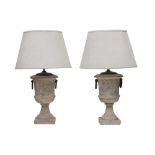 A PAIR OF PAINTED AND DISTRESSED TERRACOTTA TABLE LAMPS