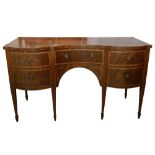 AN EARLY 19TH CENTURY STRUNG MAHOGANY AND CROSSBANDED CONCAVE FRONTED SIDEBOARD