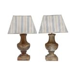 A PAIR OF DISTRESSED TERRACOTTA TABLE LAMPS