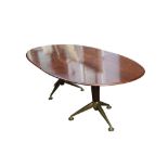 A ROSEWOOD TWIN PEDESTAL OVAL DINING TABLE