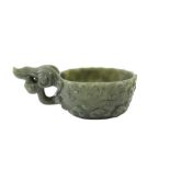 A CHINESE SPINACH-GREEN JADE ARCHAISTIC POURING VESSEL.