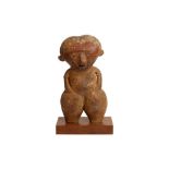 A POTTERY FIGURE OF A FEMALE, POSSIBLY PRE-COLUMBIAN