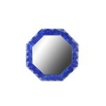 AN OCTAGONAL LAPIS LAZULI VENEERED WALL MIRROR