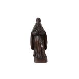 AN 18TH CENTURY CARVED WOOD FIGURE OF A MONK IN PRAYER