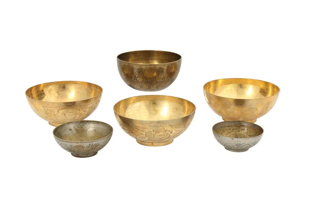 FIVE ENGRAVED BRASS MAGIC BOWLS AND A QAJAR BOWL WITH FIGURAL DECORATION Iran, 19th and 20th century