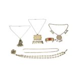 A GROUP OF FIVE SILVER AND WHITE METAL NECKLACES AND A CARNELIAN-ENCRUSTED TURKMEN BANGLE Central As