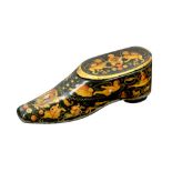 A SMALL QAJAR LACQUERED PAPIER-MÂCHÉ SHOE-SHAPED BOX Qajar Iran, 19th century