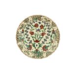 A LARGE INTACT IZNIK POTTERY DISH WITH QUATRE FLEURS DESIGN Ottoman Turkey, ca. 1570 - 1590