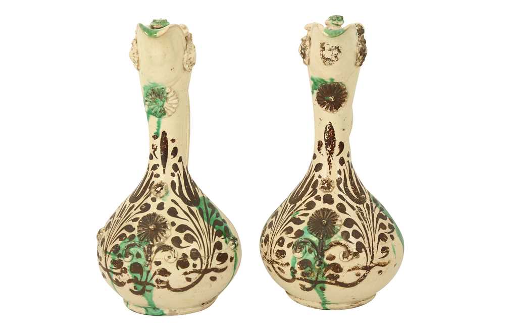 A NEAR PAIR OF GREEN-SPLASHED WHITE-GLAZED CANAKKALE POTTERY EWERS Ottoman Turkey, 19th century - Image 2 of 6