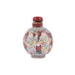 A CHINESE FAMILLE ROSE BISCUIT RETICULATED SNUFF BOTTLE.