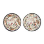 A PAIR OF CHINESE FAMILLE ROSE FIGURATIVE SAUCER DISHES.