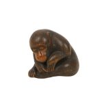 A WOOD NETSUKE OF A MONKEY.