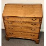 An oak bureau, the fall front with fitted interior above four long drawers on bracket feet, 93.