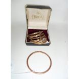 A 9ct rose gold bangle of plain circular form and fifteen other 9ct bangles, approximately 67.