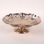 A silver fruit bowl, SJL & Co, Birmingham 1934, with pierced wavy rim raised on a circular foot,