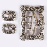 A mid 18th Century Continental silver buckle with cut decoration to the border and a pair of knee