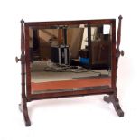 A mahogany swing frame dressing mirror on turned supports,