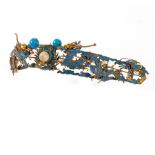 A Chinese gilt metal and kingfisher feather tiara/hair ornament of curved form centred by flaming