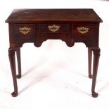 A George II mahogany three-drawer side table, circa 1740, on cabriole legs with pad feet,
