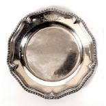 A George III silver plate, Charles Wright, London 1774, of circular shape with gadrooned rim,