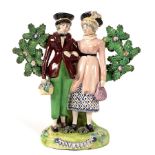 An English pearlware figure group 'The Dandies' or 'Dandy and Dandizette', early 19th century,