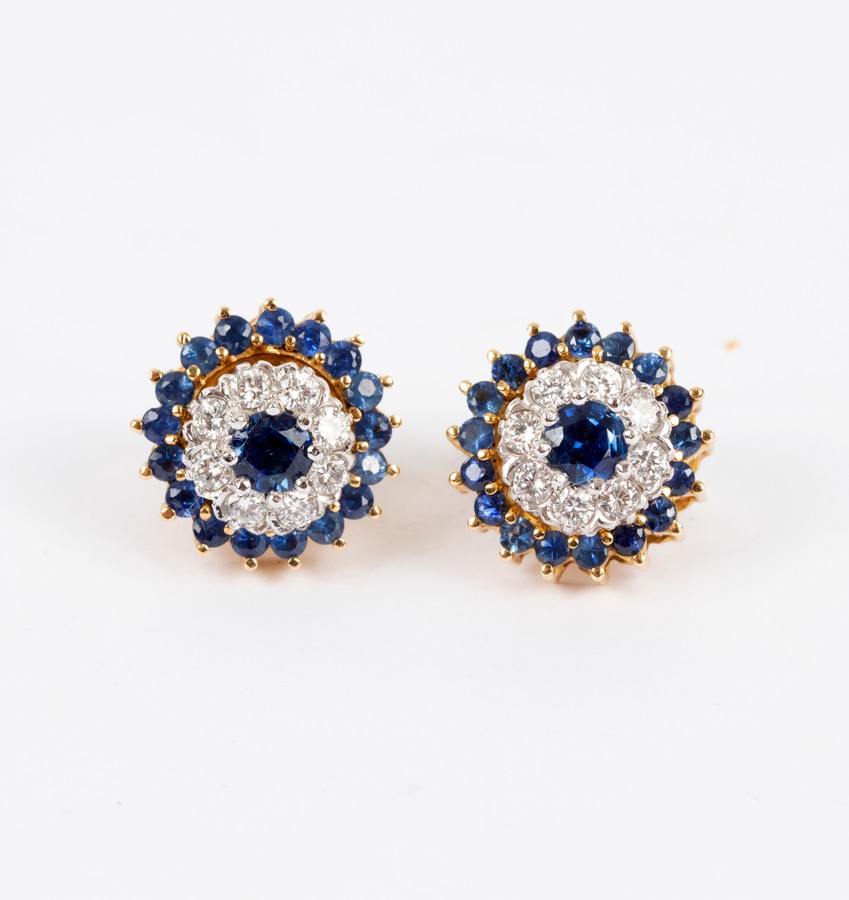 A pair of sapphire and diamond cluster ear studs with detachable outer border of sapphires,