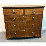 An oak bowfront chest of two short over three long drawers, on bracket feet,
