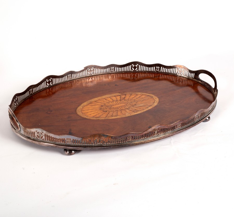 An Edwardian tray with pierced plated two-handled border,