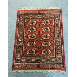 A machine made rug of Bokhara design,