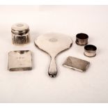 A silver backed hand mirror, two silver cigarette cases,
