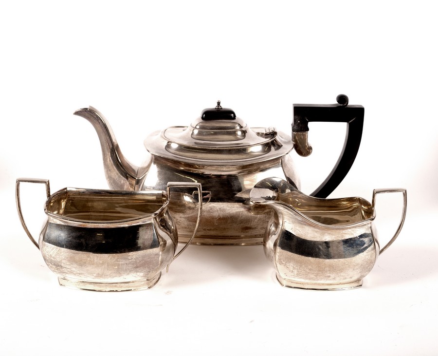 A three-piece silver tea set, Birmingham 1934, comprising teapot, sugar basin and milk jug,