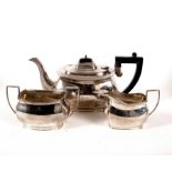 A three-piece silver tea set, Birmingham 1934, comprising teapot, sugar basin and milk jug,