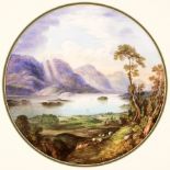 A pair of porcelain circular plaques, each painted with a view of a loch,