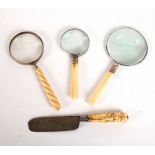 A magnifying glass with spirally reeded handle,