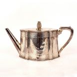 A Victorian silver teapot, WH, London 1870, of serpentine outline, engraved decoration and crest,