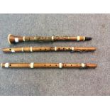 A boxwood clarinet stamped Whitaker, London and two boxwood flutes,