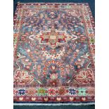 A Lilihan rug, the pale blue ground with central medallion and floral field,
