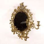 An oval wall mirror, the gilt brass frame with surround of acorns and oak leaves,