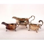 A Georgian style silver sauce boat, ED, London 1907 and two other sauce boats,