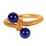 An Archaeological revival gold and lapis lazuli bangle, circa 1870,