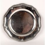 A George II silver plate, George Wickes, London 1758, of wavy outline with gadrooned rim,
