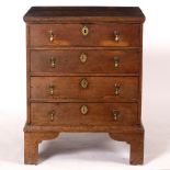 A late 17th Century style oak chest fitted four drawers on square feet, 56cm wide, 70.