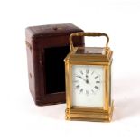 A French gilt brass carriage clock with repeat mechanism, the enamel dial indistinctly signed,