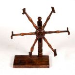 A fruitwood wool winder with spindle turned supports and square base, 43cm wide,
